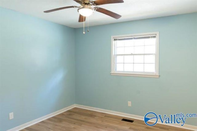 spare room featuring ceiling fan and wood-type flooring