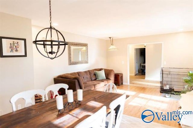 dining room featuring light hardwood / wood-style flooring and a chandelier