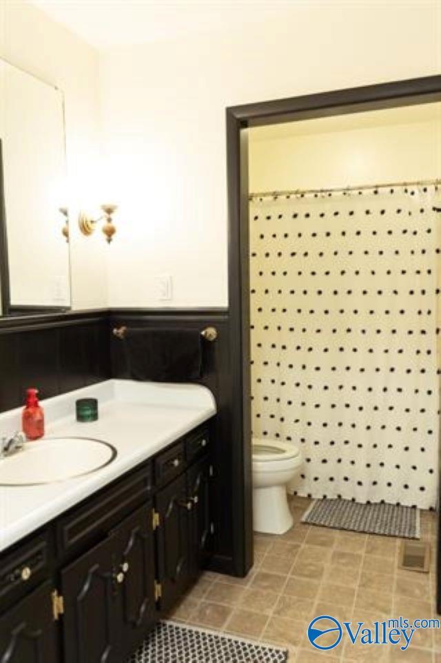 bathroom featuring vanity and toilet