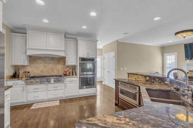 kitchen featuring white cabinetry, sink, stainless steel appliances, and dark hardwood / wood-style floors