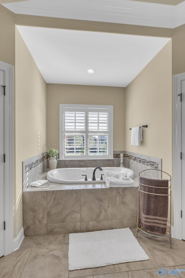 bathroom with tiled bath and tile patterned flooring