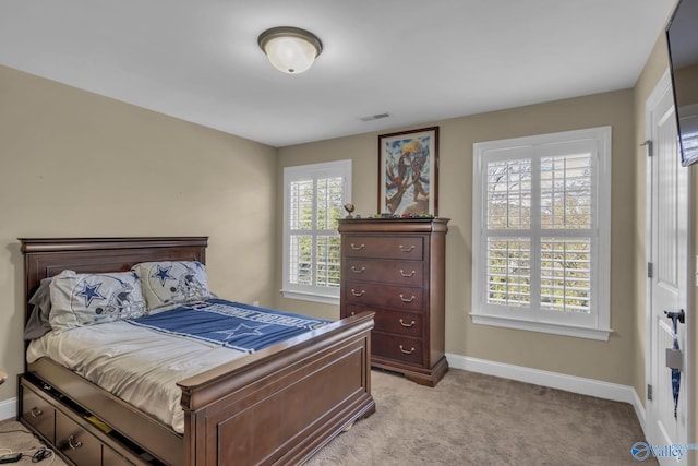 bedroom featuring light colored carpet