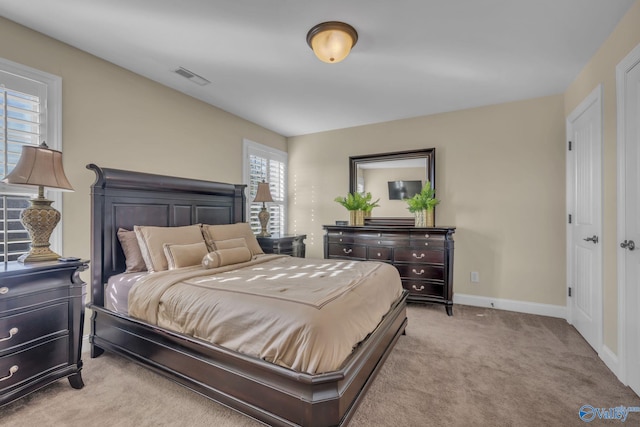 bedroom with light colored carpet