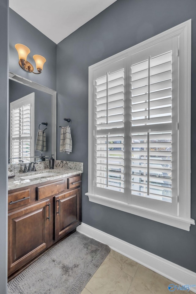 bathroom with tile patterned flooring, vanity, and plenty of natural light