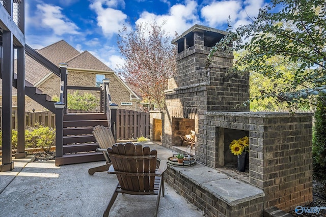 view of patio / terrace featuring an outdoor brick fireplace