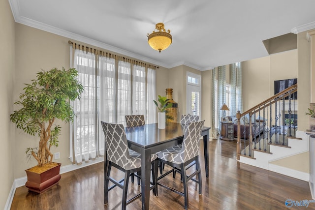 dining room with ornamental molding, plenty of natural light, and dark wood-type flooring