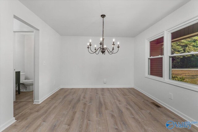 interior space featuring light hardwood / wood-style flooring and an inviting chandelier