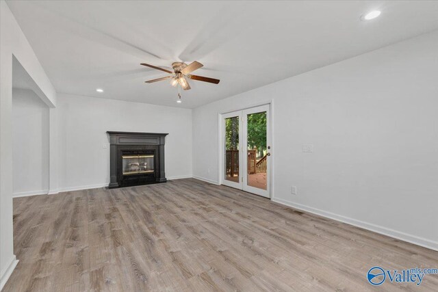 unfurnished living room with ceiling fan and light hardwood / wood-style floors