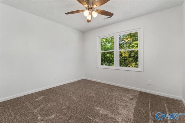 carpeted empty room with a textured ceiling and ceiling fan