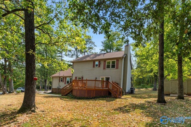 rear view of house featuring a wooden deck