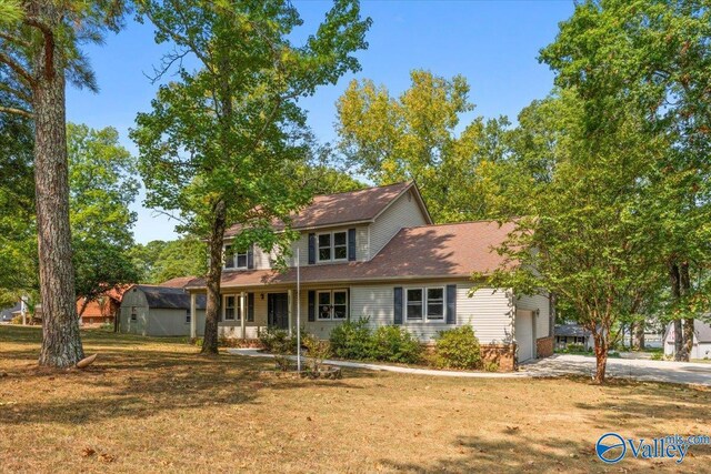 front facade with a garage and a front lawn