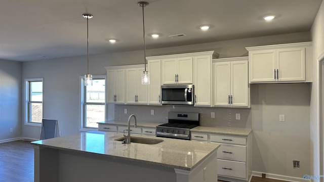 160 Saddle St, New Market, AL 35761 - kitchen with appliances with stainless steel finishes, a sink, white cabinetry, baseboards, and tasteful backsplash