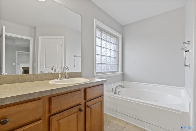 bathroom with tile patterned flooring, vanity, and a washtub