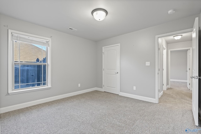 unfurnished bedroom featuring light colored carpet