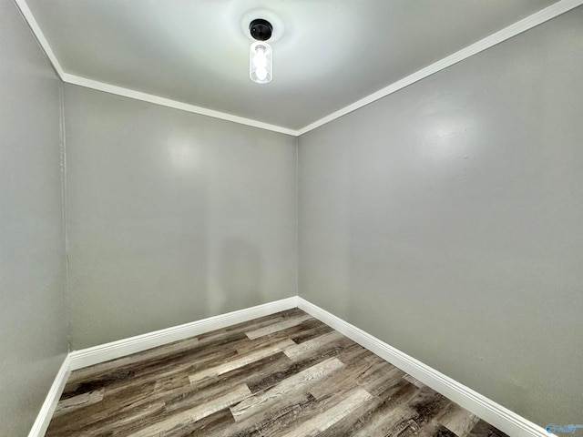 empty room featuring ornamental molding and hardwood / wood-style floors