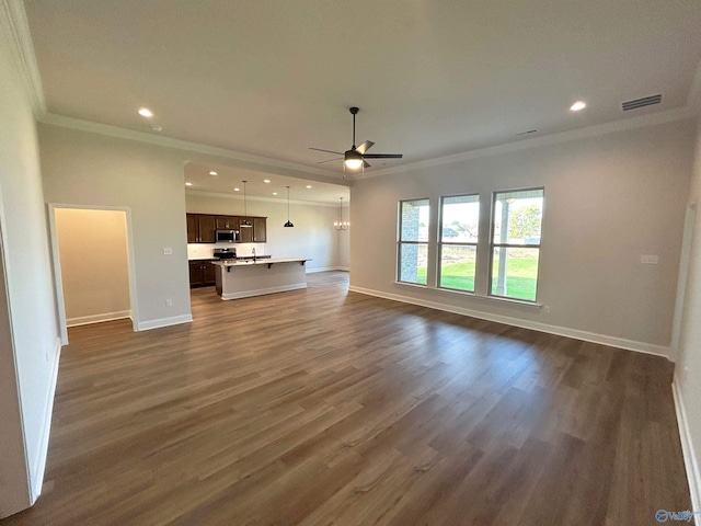 unfurnished living room featuring crown molding, ceiling fan, and dark hardwood / wood-style flooring