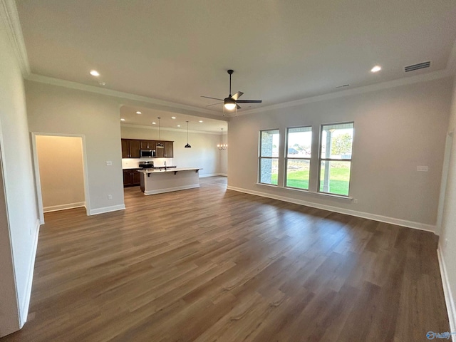 24081 Quints Dr, Athens, AL 35613 - unfurnished living room featuring crown molding, ceiling fan, baseboards, dark wood-style floors, and recessed lighting