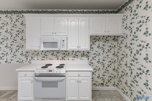 kitchen with white appliances and white cabinetry