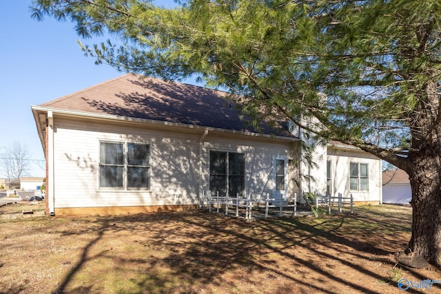 rear view of house featuring a yard