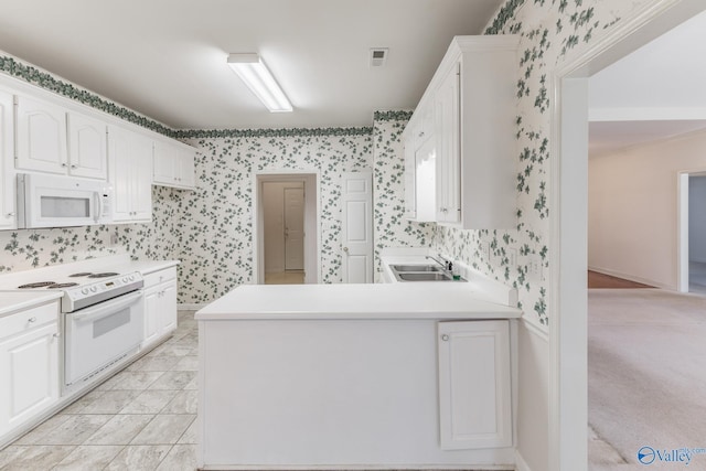 kitchen with white appliances, white cabinetry, sink, kitchen peninsula, and light colored carpet