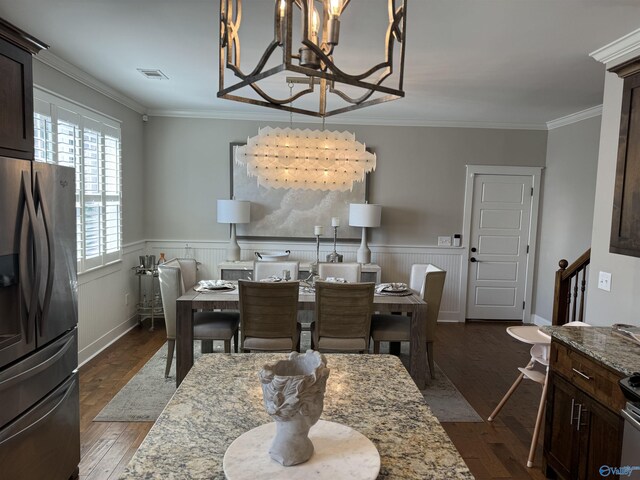 kitchen featuring crown molding, backsplash, dark brown cabinets, stainless steel appliances, and light stone countertops