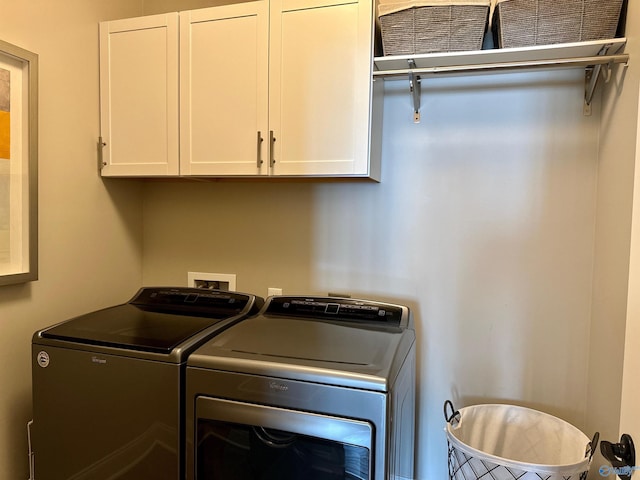 washroom featuring cabinet space and independent washer and dryer