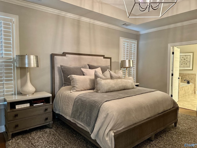 bedroom with ornamental molding, ensuite bath, visible vents, and a notable chandelier