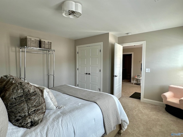 bedroom featuring light carpet and a closet