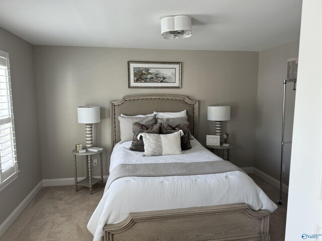 bedroom with light colored carpet, ornamental molding, and a crib