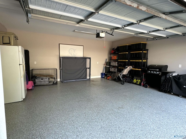 garage with freestanding refrigerator and a garage door opener