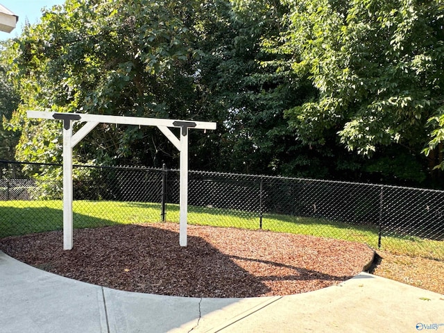 view of property's community featuring a yard, playground community, and fence