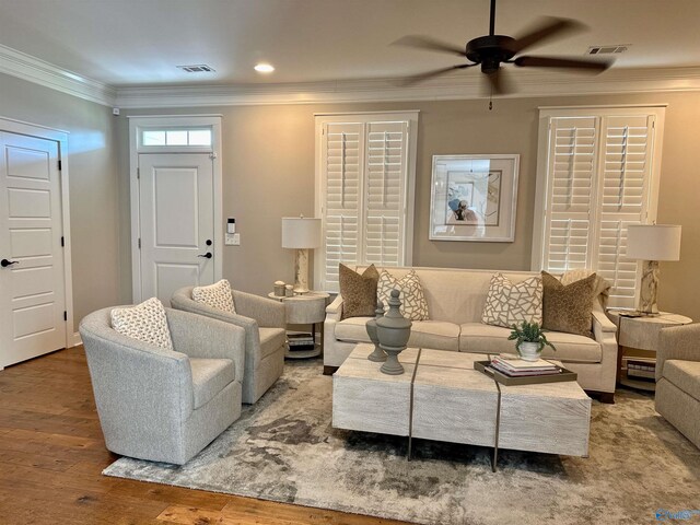 living room featuring crown molding, ceiling fan, and hardwood / wood-style flooring