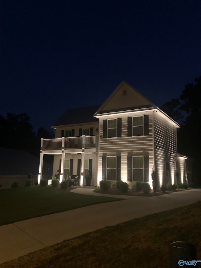 view of front of house featuring a balcony