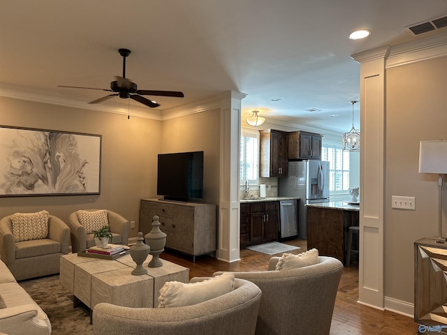 living room with crown molding, ceiling fan, dark hardwood / wood-style flooring, and sink