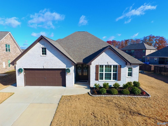 view of front of house with a garage and a front lawn