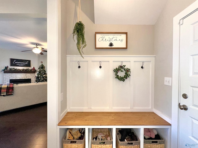 mudroom with ceiling fan and a fireplace