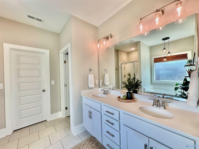 bathroom with tile patterned floors, vanity, and separate shower and tub