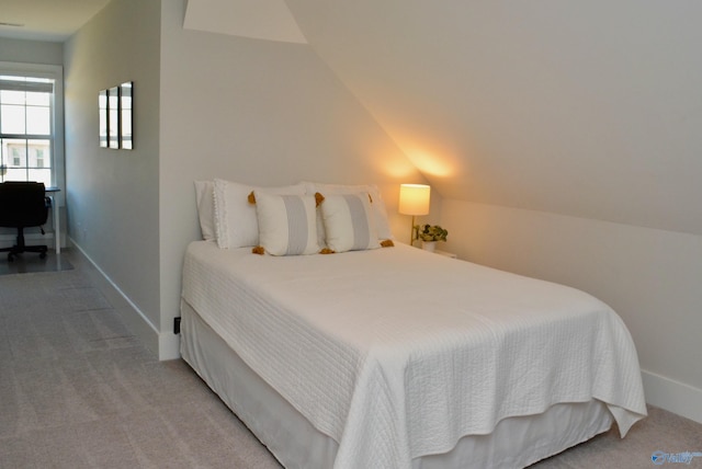 bedroom featuring carpet floors and lofted ceiling