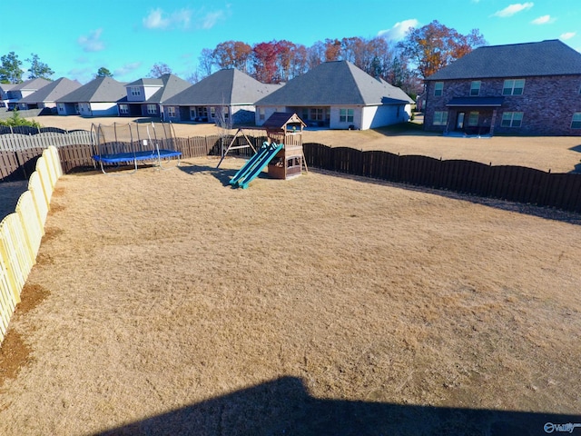 exterior space featuring a trampoline and a playground