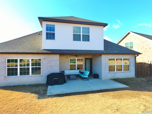 rear view of property featuring a yard, a patio, and an outdoor hangout area