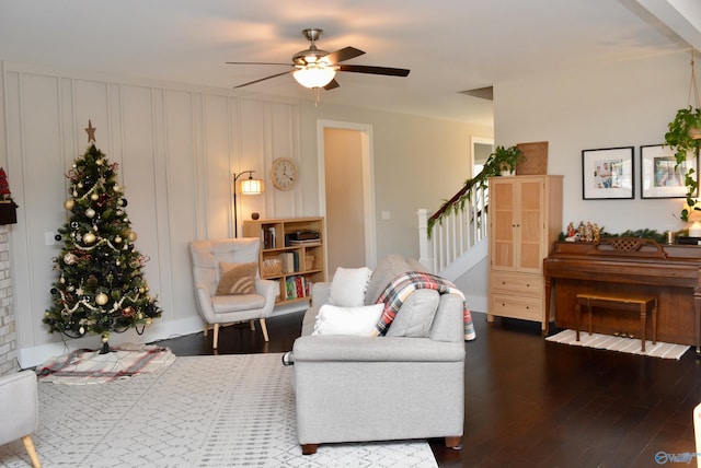 living room featuring wood-type flooring and ceiling fan