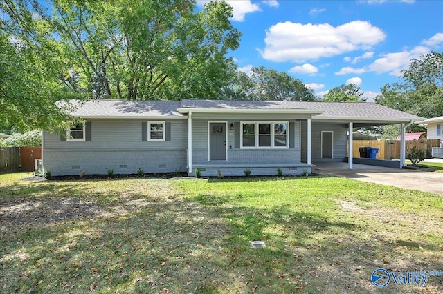 ranch-style home with a front yard and a carport