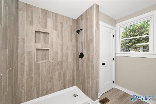 bathroom with a tile shower