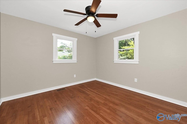 spare room with ceiling fan, hardwood / wood-style flooring, and plenty of natural light