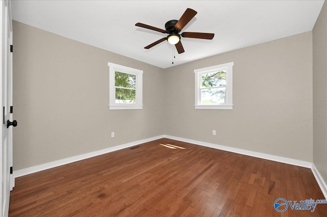 empty room featuring ceiling fan and dark wood-type flooring