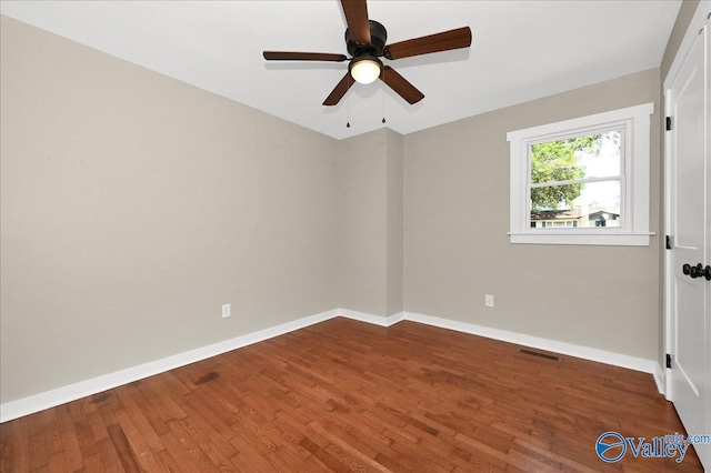 empty room featuring ceiling fan and hardwood / wood-style flooring