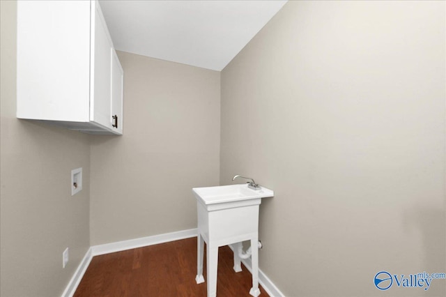 laundry room featuring cabinets, hookup for a washing machine, and dark wood-type flooring