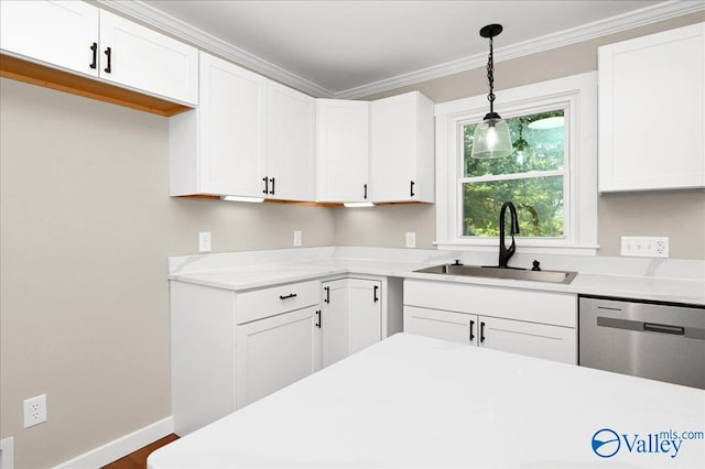 kitchen featuring ornamental molding, decorative light fixtures, sink, and white cabinetry