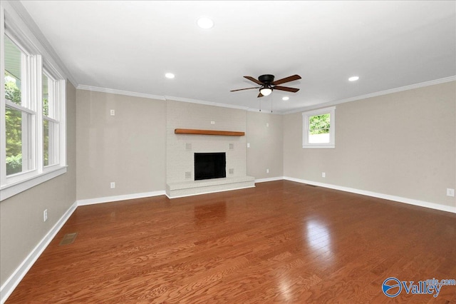 unfurnished living room with a fireplace, ornamental molding, hardwood / wood-style floors, and ceiling fan