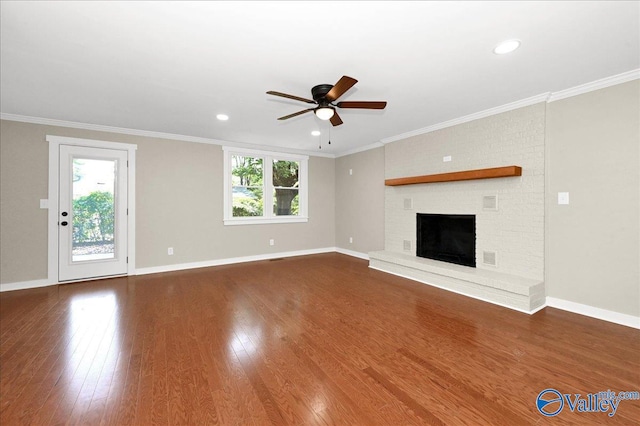 unfurnished living room featuring a fireplace, hardwood / wood-style floors, ceiling fan, and a wealth of natural light